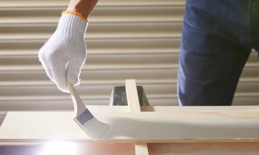 white paint being applied to woodwork